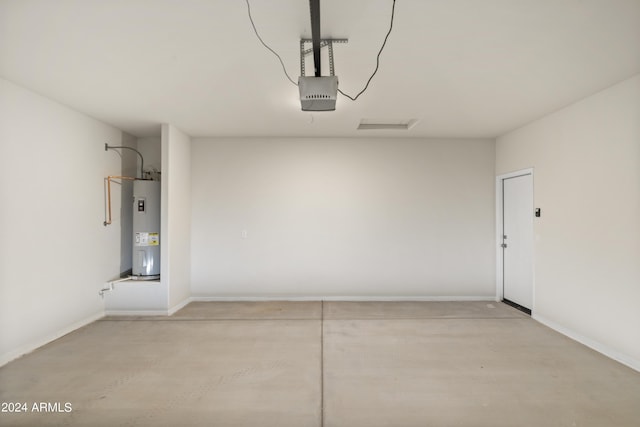 garage with baseboards, a garage door opener, and electric water heater