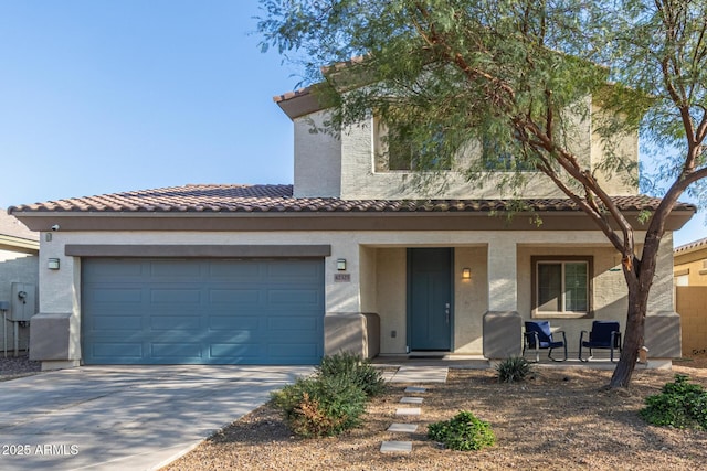 view of front of home with a porch, concrete driveway, a tile roof, and stucco siding