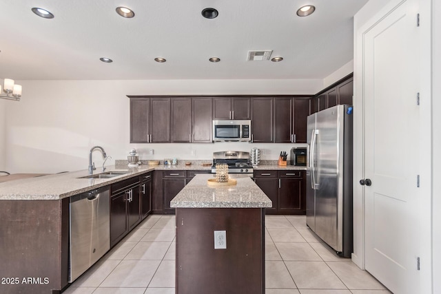 kitchen with light tile patterned floors, visible vents, appliances with stainless steel finishes, and a sink