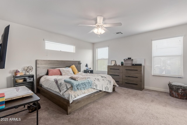 bedroom featuring visible vents, carpet floors, baseboards, and a ceiling fan