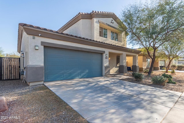 view of front of home with stucco siding, a tiled roof, and concrete driveway