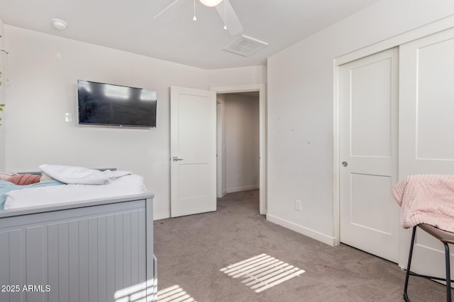 bedroom with a ceiling fan, visible vents, baseboards, a closet, and light colored carpet