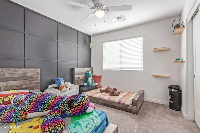 carpeted bedroom with baseboards, visible vents, and ceiling fan