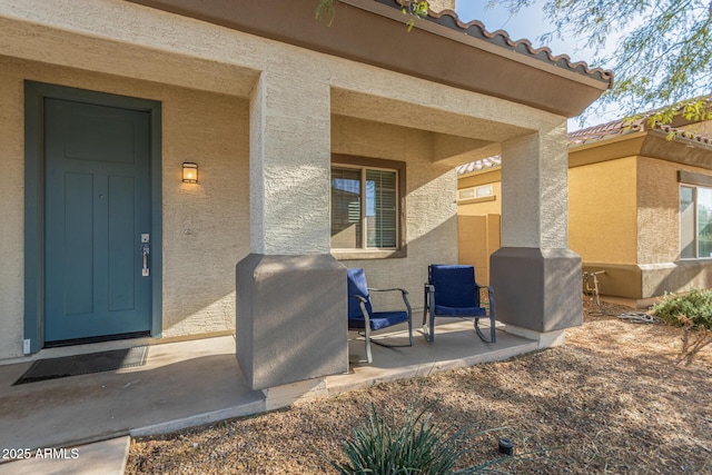 property entrance with stucco siding