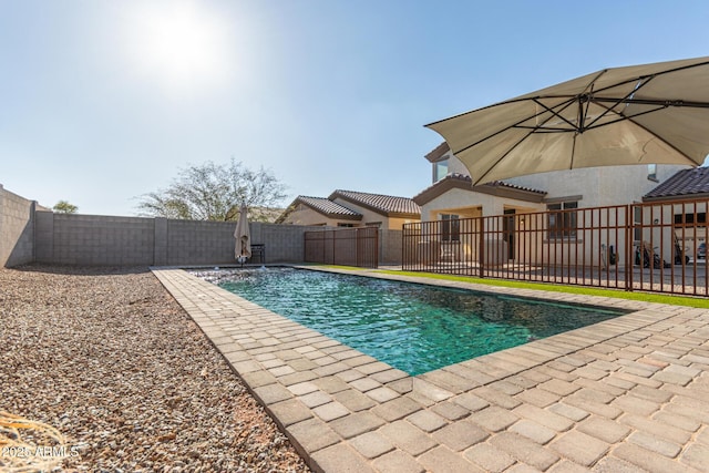 view of swimming pool featuring a patio, a fenced backyard, and a fenced in pool