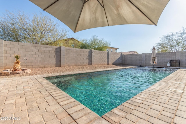 view of swimming pool featuring a fenced in pool, a patio, and a fenced backyard