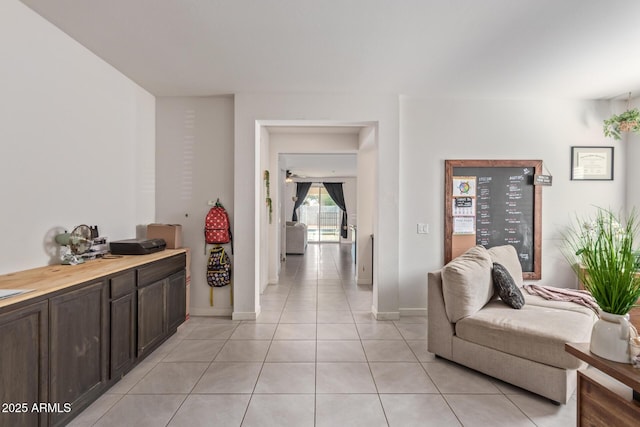 living room featuring light tile patterned flooring and baseboards