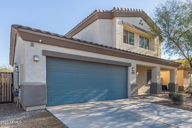 view of front of property with stucco siding, driveway, and an attached garage