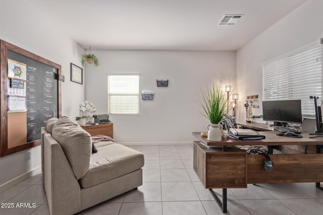 home office featuring light tile patterned floors, visible vents, and baseboards