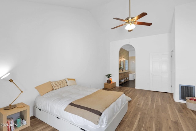 bedroom featuring high vaulted ceiling, ceiling fan, ensuite bathroom, and hardwood / wood-style floors