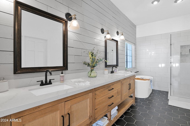 bathroom with vanity, tile walls, a bath, and tile patterned floors