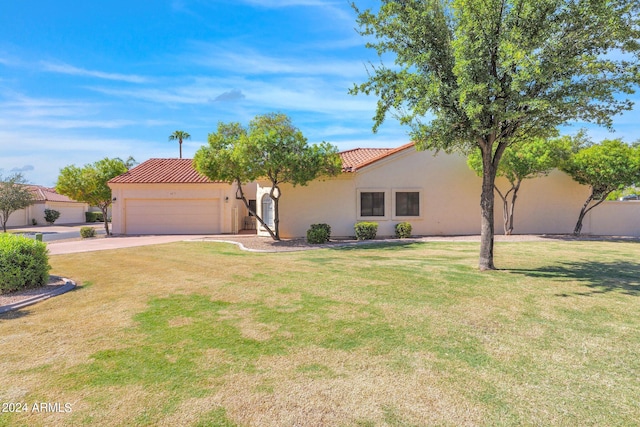 view of front of house with a garage and a front yard