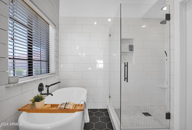 bathroom featuring independent shower and bath, tile walls, and tile patterned floors