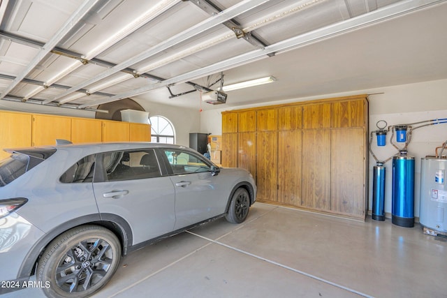 garage featuring water heater and a garage door opener