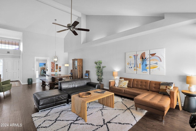 living room with beamed ceiling, dark hardwood / wood-style floors, ceiling fan, and high vaulted ceiling