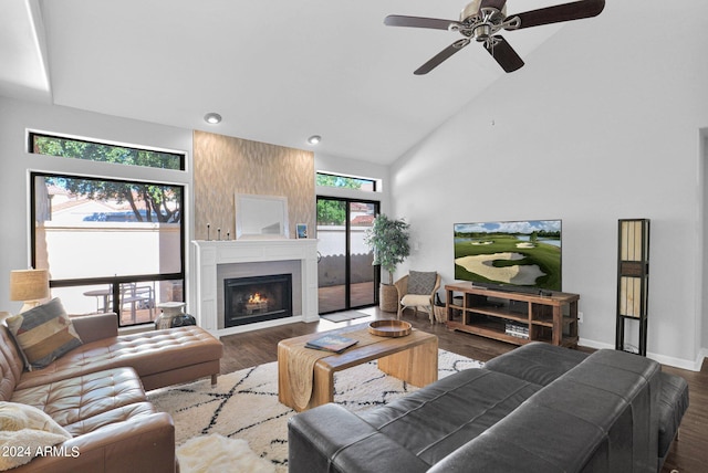 living room with high vaulted ceiling, ceiling fan, dark hardwood / wood-style floors, and a fireplace