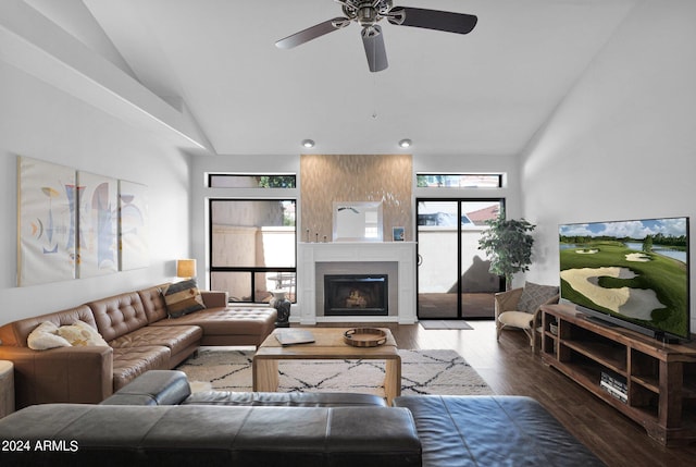 living room featuring a large fireplace, vaulted ceiling, ceiling fan, and dark hardwood / wood-style floors