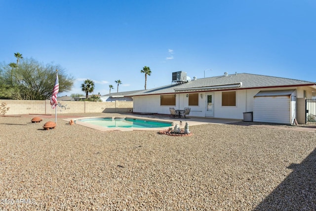 view of pool featuring a patio and central AC unit