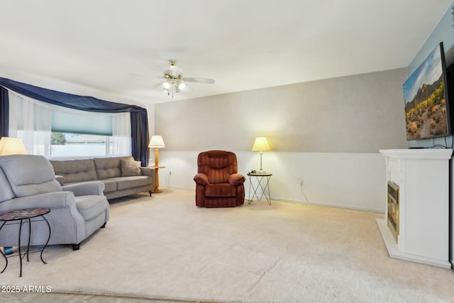 carpeted living room featuring ceiling fan