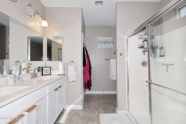 bathroom with vanity, tile patterned flooring, and an enclosed shower