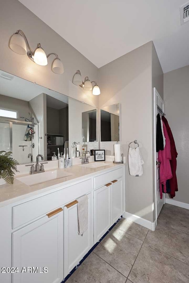 bathroom featuring vanity, tile patterned floors, and walk in shower