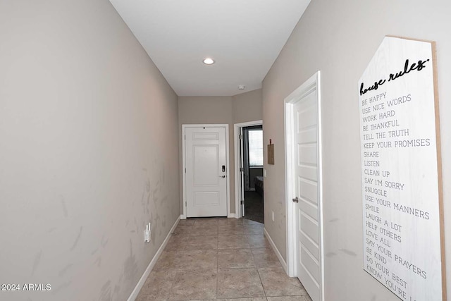 corridor with light tile patterned floors