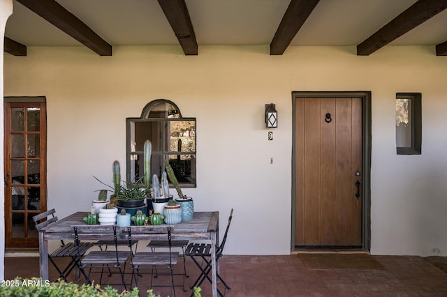 view of exterior entry featuring covered porch