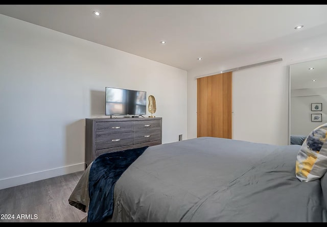 bedroom with dark hardwood / wood-style flooring