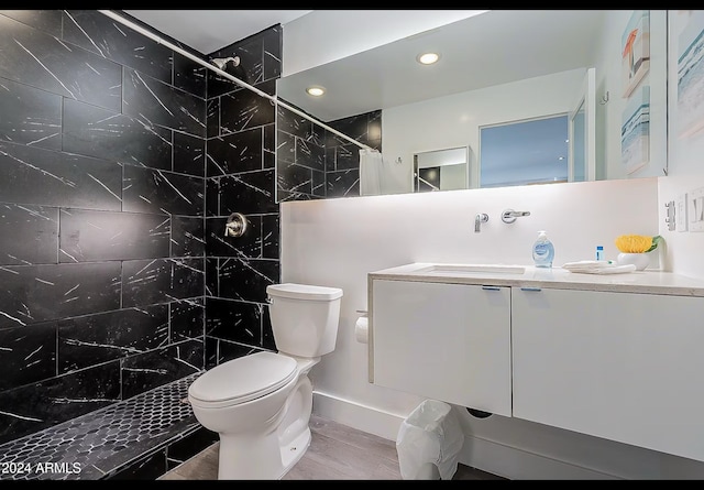 bathroom featuring curtained shower, vanity, wood-type flooring, and toilet