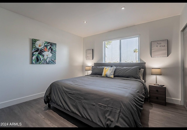 bedroom with dark wood-type flooring