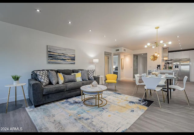 living room featuring a notable chandelier and hardwood / wood-style flooring