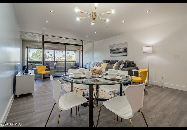 dining space featuring hardwood / wood-style flooring and an inviting chandelier