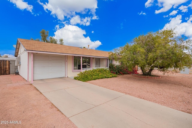 ranch-style home with stucco siding, a porch, concrete driveway, and a garage