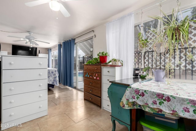 bedroom featuring light tile patterned flooring, a ceiling fan, and access to exterior