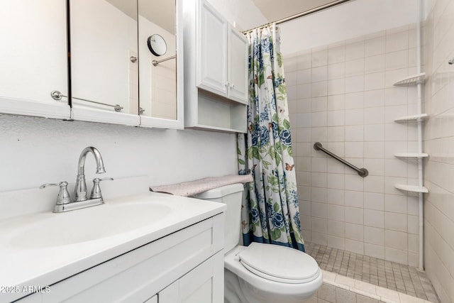 bathroom featuring toilet, vanity, and a tile shower