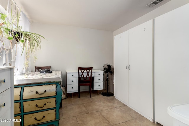 bedroom with light tile patterned floors and visible vents