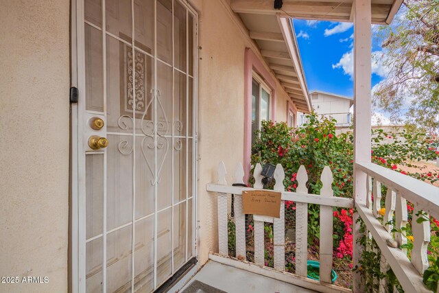 entrance to property featuring stucco siding