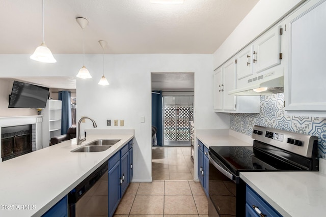 kitchen with under cabinet range hood, light countertops, appliances with stainless steel finishes, blue cabinets, and a sink