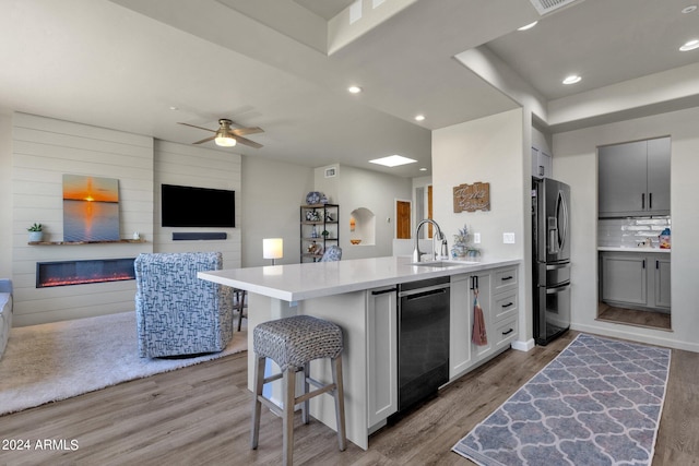 kitchen with wood-type flooring, ceiling fan, and gray cabinets