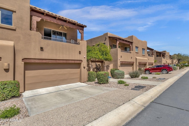 view of front of house featuring a garage and a balcony