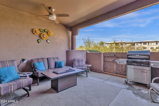 view of terrace with grilling area, ceiling fan, and an outdoor fire pit