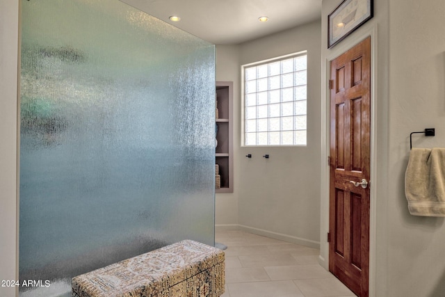 bathroom with built in features and tile flooring