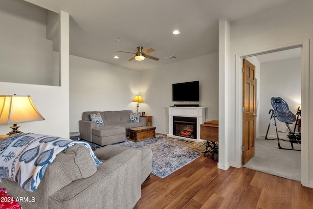 living room with ceiling fan and carpet floors