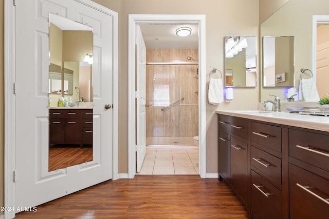 9550 E Thunderbird Rd Unit 152, Scottsdale, AZ 85260 - bathroom featuring a shower stall, vanity, and wood finished floors