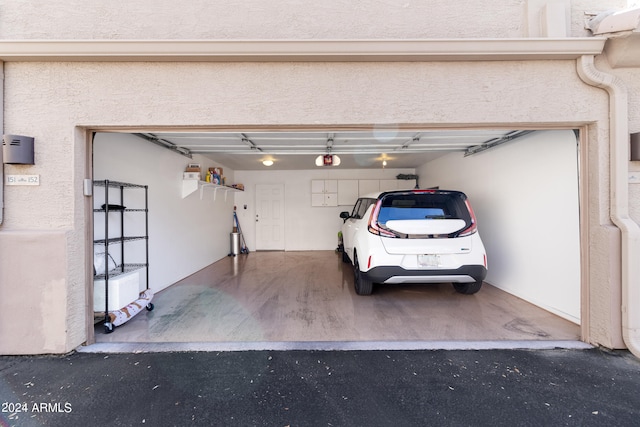 9550 E Thunderbird Rd Unit 152, Scottsdale, AZ 85260 - garage with a garage door opener and asphalt driveway