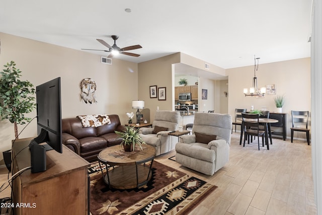 9550 E Thunderbird Rd Unit 152, Scottsdale, AZ 85260 - living area featuring a ceiling fan, a chandelier, and light wood-style floors