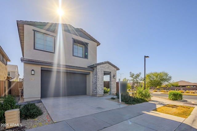 view of front of house with fence, driveway, an attached garage, stucco siding, and stone siding