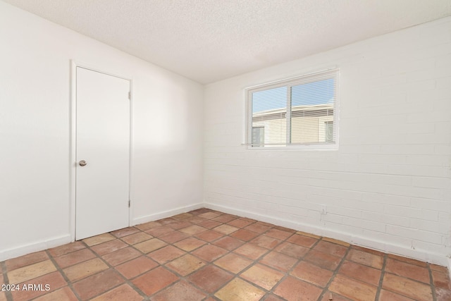 empty room featuring a textured ceiling