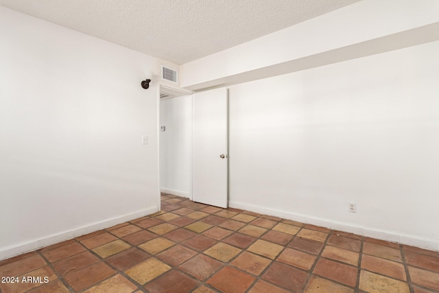 empty room featuring a textured ceiling