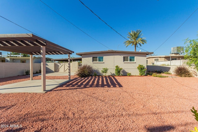 back of property with a carport